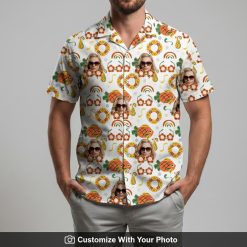 Man wearing white Hawaiian shirt featuring sunglasses face, pineapples, and rainbows
