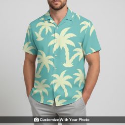 Man in light teal Hawaiian button down with pale yellow palm tree pattern