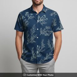 Man in navy blue Hawaiian shirt featuring light blue leaf botanical pattern