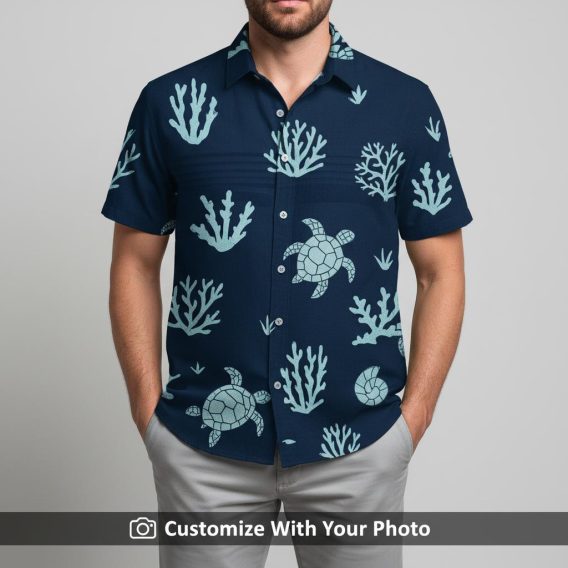 Man in navy blue Hawaiian shirt with ocean sea turtle and coral design outdoors
