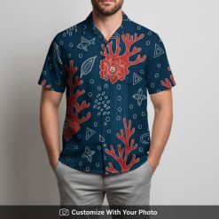 Man wearing navy blue Hawaiian shirt with red flowers, corals and geometric leaves