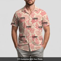Man models custom embroidered Hawaiian shirt with pink and beige leaf pattern