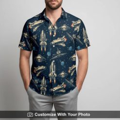 Man models spaceship pattern Hawaiian shirt featuring planets and starry blue fabric