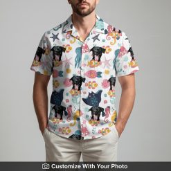 Man in fun tropical Spongebob Hawaiian shirt with black dog and pink sea creatures
