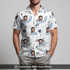 Man wearing white Hawaiian shirt with cartoon dinosaurs, surfboards, palm trees, blue highlights.