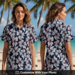 Woman in navy blue Hawaiian shirt with white hibiscus flowers and red accents