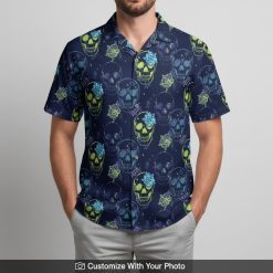 Man in neon skull Hawaiian shirt with lime green skulls and blue floral designs outside