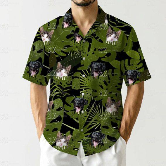 Hawaiian shirt with cat face prints and dog faces among green tropical leaves