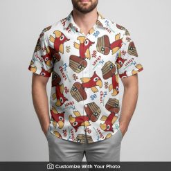 man grilling at BBQ in white shirt featuring cartoon parrot and chests