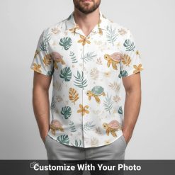 Hawaiian shirt with sea turtle face print worn by man, pastel turtles and orange flowers seaside