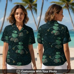 Woman wearing Star Wars Hawaiian shirt with green robot, stars, and planets design
