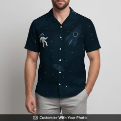Man wearing Star Wars Hawaiian shirt featuring astronaut, rockets, and moon motifs