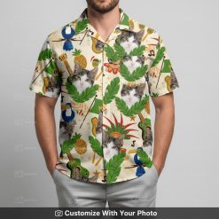 Man wearing Taco Cat Hawaiian shirt, featuring cat face with pineapples and musical shapes