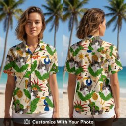 Woman wearing Taco Cat Hawaiian shirt with cat face, leaves, toucans, and pineapples design