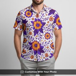 Man in white Hawaiian shirt featuring vibrant purple and orange floral pattern