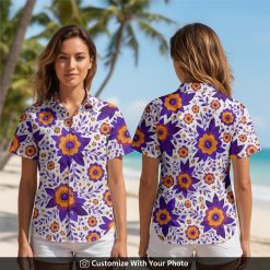 Woman wearing white Hawaiian shirt with purple and orange flowers, smiling outdoors