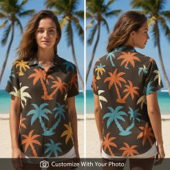 Woman wearing a tropical button up shirt with orange and blue palm trees on black