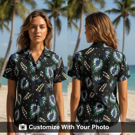 Woman wearing black Hawaiian shirt with palm leaf and floral print, navy and green tones