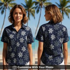 Woman wearing black Hawaiian shirt with large pink flowers and tropical leaves outdoors