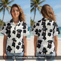 Woman wearing a black and white Hawaiian shirt with dog face and hibiscus pattern