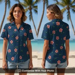 Woman wearing deep blue Hawaiian shirt with pink floral print and green leaves outdoors