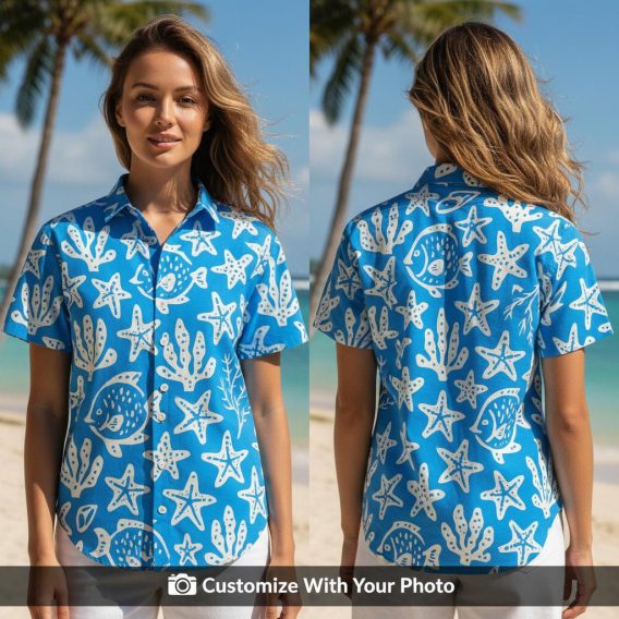 Woman wearing blue Hawaiian shirt with white fish, starfish, and coral print, smiling outdoors