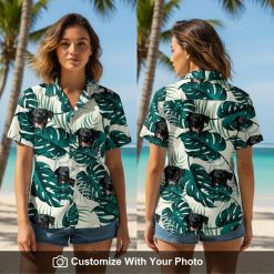 Woman wearing white and green Hawaiian shirt with black dog face and monstera leaves