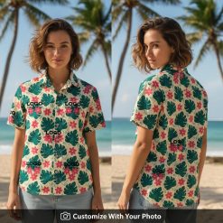 Woman wearing custom logo aloha shirt with green monstera leaves and pink flowers