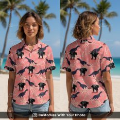 Woman wearing pink dinosaur aloha shirt with black dog face and palm trees