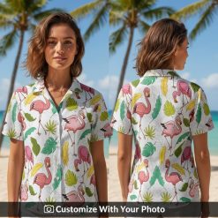 Woman wearing white Hawaiian shirt with pink flamingos and lush green tropical leaves