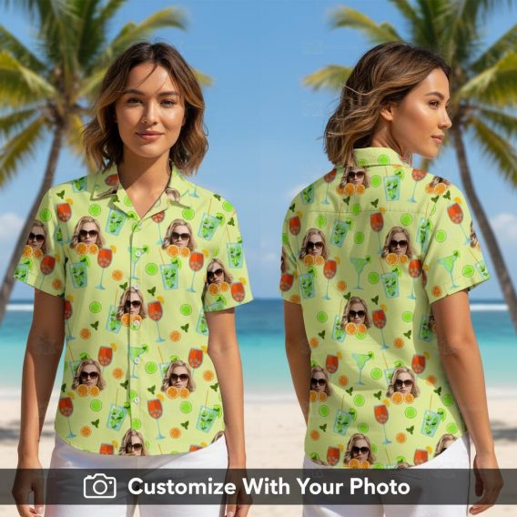 Woman wearing green Hawaiian shirt with custom face, cocktails, citrus and leaves design