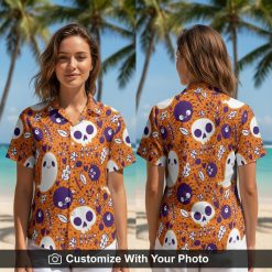 Woman wearing Halloween button-up shirt with orange, purple, and white skulls and ghosts