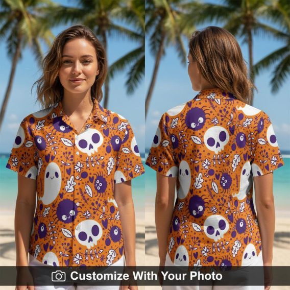 Woman wearing Halloween button-up shirt with orange, purple, and white skulls and ghosts