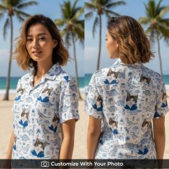 Woman wearing blue Hawaiian shirt with cat face, dinosaur, palm trees, and waves pattern