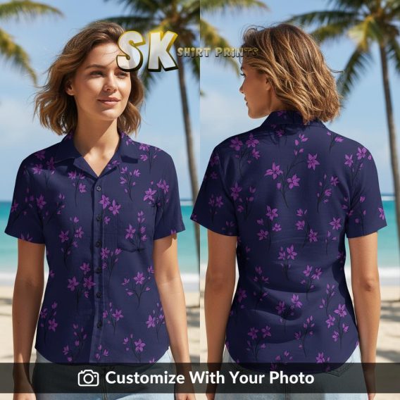 Woman smiling in a tropical floral aloha shirt with pink flowers on dark blue background