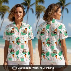 Woman wearing vibrant green and orange Hawaiian shirt with sunglasses face and leaf pattern