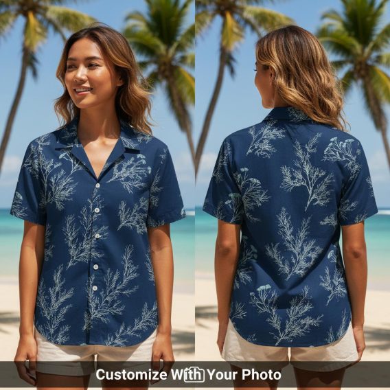 Woman wearing navy Hawaiian shirt with light blue leaf print, tropical subtle look