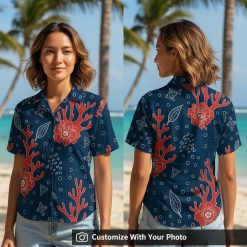 Woman in navy blue Hawaiian shirt with red flowers, fish and coral pattern outdoors
