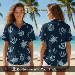 Woman wearing navy blue Hawaiian shirt with sea turtles, coral, and island vibes