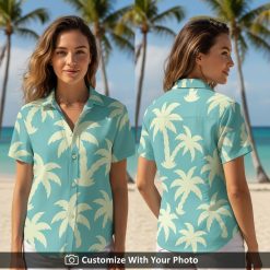Woman wearing a light blue tropical button down shirt with yellow palm tree print outdoors