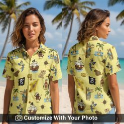 Woman wearing yellow pirate Hawaiian shirt with palm trees, maps, and pirate ship details