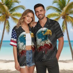 Person wearing American eagle tropical Hawaiian shirt in relaxed vacation pose by palm trees