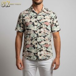 Man in floral Hawaiian shirt standing outdoors in relaxed vacation pose