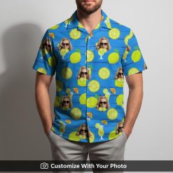 Man in blue tropical shirt featuring citrus fruit, face in sunglasses, cocktail umbrellas