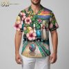 Person modeling retro style bowling Hawaiian shirt with pins and ball pattern in relaxed pose