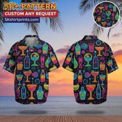 Man wearing cocktail print Hawaiian shirt with tropical drinks pattern, standing on beach setting