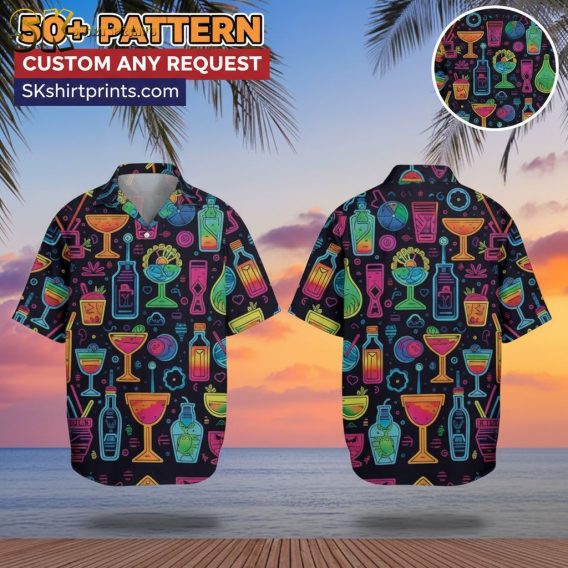 Man wearing cocktail print Hawaiian shirt with tropical drinks pattern, standing on beach setting