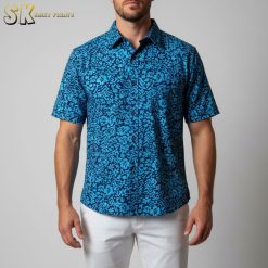 Man in relaxed pose wearing Cooke Street Aloha shirt with island pattern in beach-themed lifestyle photo