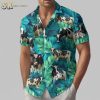 Cow print shirts with tropical Hawaiian design featuring cows and green foliage on blue fabric