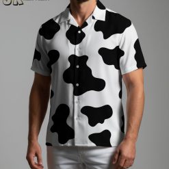 Male model poses in cow print t shirt Aloha style summer outdoor scene